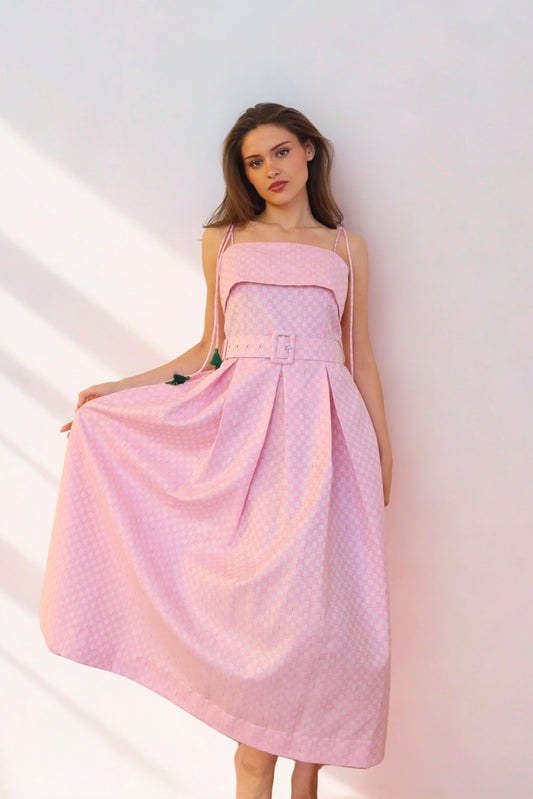 Woman wearing a pink strapless dress against a white background